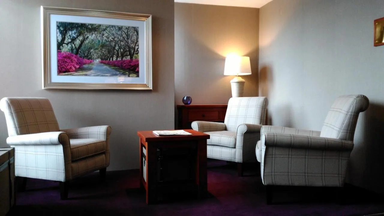 a waiting room with chairs and a painting on the wall at The Craighaar Hotel in Aberdeen