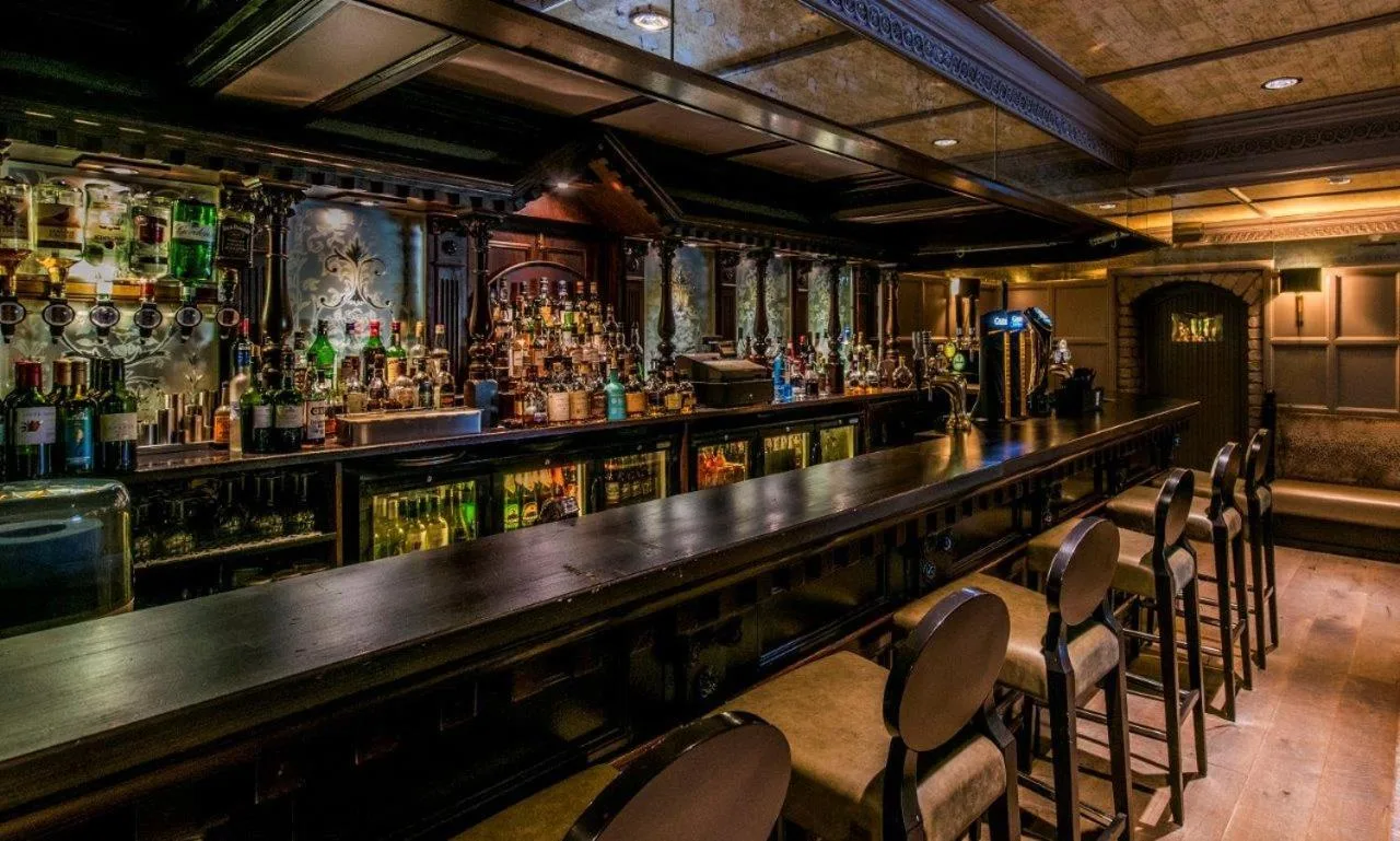 a bar with a lot of bottles of alcohol at The Craighaar Hotel in Aberdeen